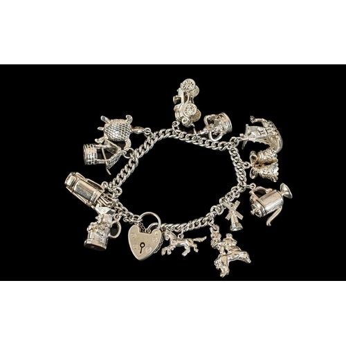 194 - A Good Quality Vintage Sterling Silver Charm Bracelet Loaded with 13 Silver Charms of Various Subjec... 