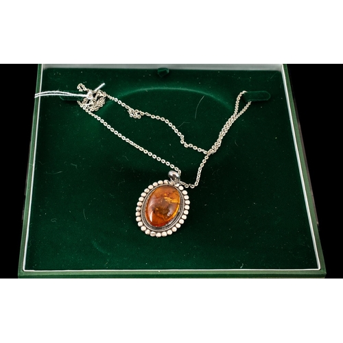 261 - Amber & Silver Pendant, suspended on a fancy silver 24'' chain, pendant size with bale 55 ml.