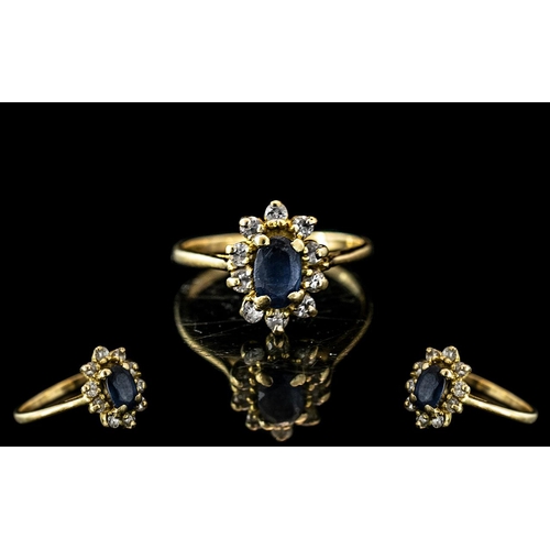 267 - Ladies 9ct Gold Sapphire & Diamond Dress Ring, oval sapphire surrounded by small diamonds in a flowe... 