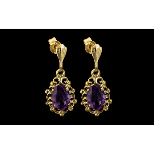 48A - Antique Pair of Attractive 9ct Gold Amethyst Set Drop Earrings.  The oval shaped faceted amethyst of... 