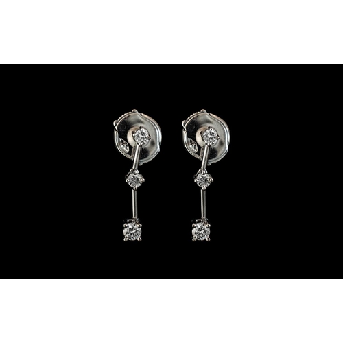 227 - Pair of 18ct White Gold Diamond Drop Earrings, for pierced ears, weight 2.05, set with three graduat... 