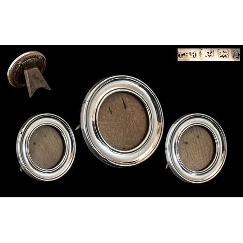 127 - A Fine Trio of Sterling Silver Photo Frames of Circular Shape with Oak backs. Makers Mark T.H.H. For... 