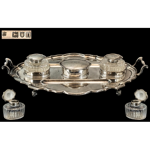 132 - A Large Silver Twin Handled Desk Tidy of scalloped molded form with 2 wells, a pair of ink wells and... 