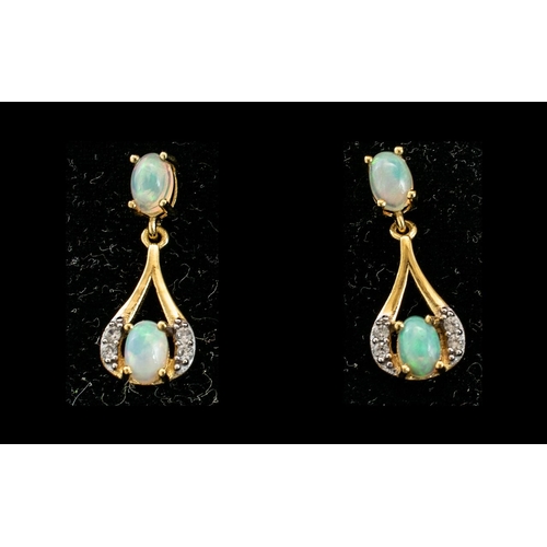 250 - Opal Drop Earrings, each earring having a round cut opal cradled in a loop of gold vermeil and silve... 