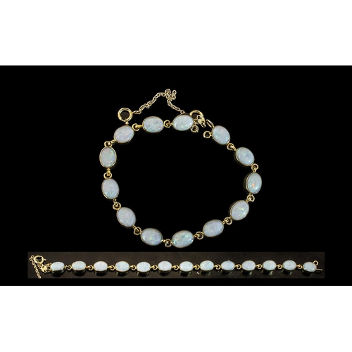 44A - Ladies 9ct Gold Opal Set Bracelet, Set With 13 Oval Shaped Opals of Good Colour with Safety Chain. M... 