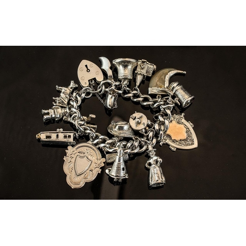 245A - Ladies Silver Charm Bracelet, Clasp Is Hallmarked and Some Charms Also. Charms Includes Bell, Shield... 