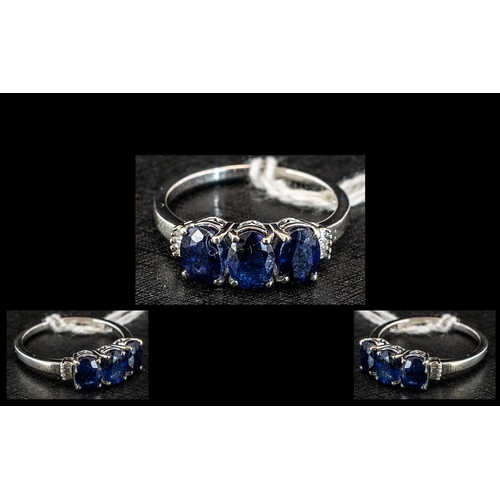 260 - Sapphire and Diamond Trilogy Ring, three oval cut sapphires, totalling 3cts, create the trilogy form... 