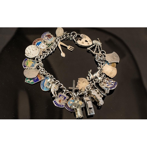 261 - Silver Charm Bracelet With Heart Shaped Locket. Weight Approx 57.9 grams.