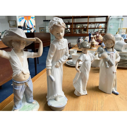 701 - A Collection of Nao by Lladro Figures (3) in total. Comprises a boy with cowboy hat on, a girl in ni... 