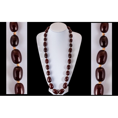 137A - Faux Cherry Amber Double Knotted Barrel Shaped Beaded Necklace. Cherry Amber Double Knotted Beaded N... 