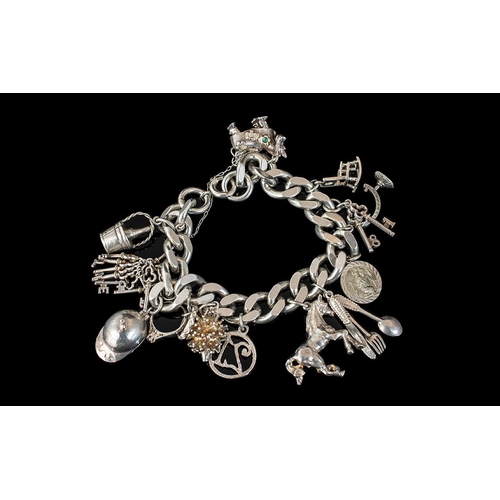 276 - A Vintage Sterling Silver Charm Bracelet, loaded with eleven (11) good silver charms, all marked for... 