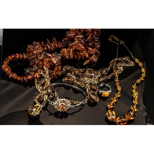 310 - Collection of Amber Coloured Jewellery, including necklaces, bracelet and ring.