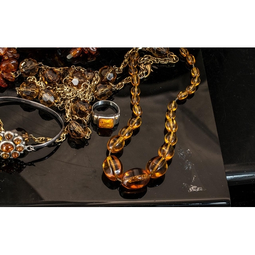 310 - Collection of Amber Coloured Jewellery, including necklaces, bracelet and ring.