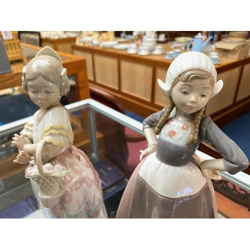 651 - Lladro Dutch Girl Figurine, No. 5064, 11'' tall, together with a Lladro Nao figure girl with basket,... 