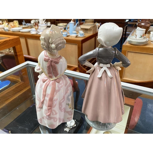 651 - Lladro Dutch Girl Figurine, No. 5064, 11'' tall, together with a Lladro Nao figure girl with basket,... 