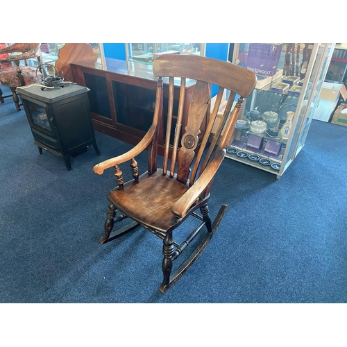 1031 - Traditional Oak Rocking Chair with spindle back and carved centre panel.  Measures 40'' tall, width ... 