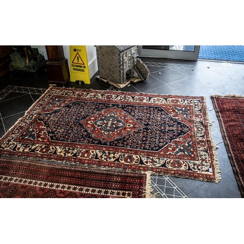 1050 - Two Wool Rugs, both with signs of wear, traditional wool rug border pattern with central diamond des... 