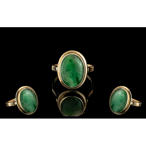 26A - Ladies 9ct Gold Attractive Jade Set Dress Ring marked 9ct to interior of shank. The oval shade Jade ... 