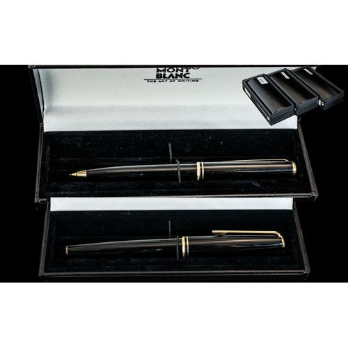 478 - A Mont Blanc Fountain Pen, black barrel and cap, gold tone clip and bands, 14ct gold nib.  Together ... 