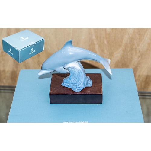 542 - Lladro Baby Dolphin with Stand - Titled ' Lucky Dolphin ' Model No 01008104. Approx Size 4 by 3 Inch... 