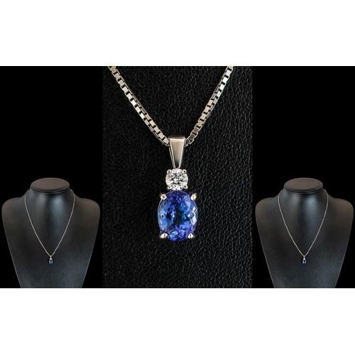 56 - Ladies 18ct White Gold Pendant Set with a Tanzanite & Diamond, attached to a 9ct white gold chain.  ... 