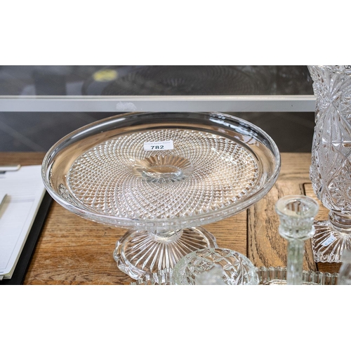 782 - Quantity of Glassware, comprising a 10'' tall vase on a square base, an 11'' diameter cake plate rai... 