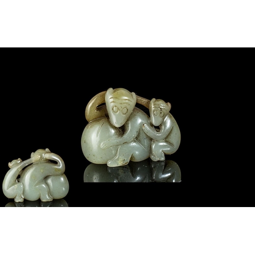 830 - A Small Jade Carving Depicting Two Monkeys 2 inches long.