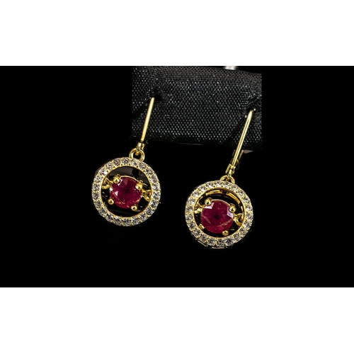 85 - Ruby 'Moving Gemstone' Drop Earrings, with an unusual suspended setting for each 1.5ct, round cut, r... 