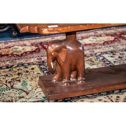 1029 - A Early 20th Century Coffee Table Shaped Rectangular Top Raised On Carved Elephant Supports With Pla... 