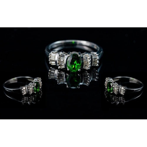 208 - Contemporary 9ct White Gold Emerald and Diamond Set Ladies Ring, the emerald, of approx.1ct, flanked... 