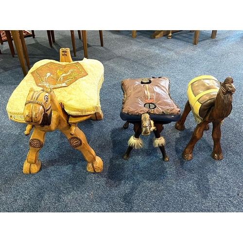 1025 - A Collection Of Three Camel Stools All Three Of Various Designs Of A Wooden Construction With Padded... 