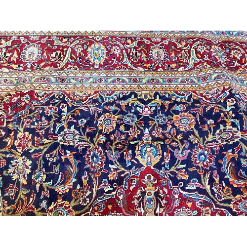 1041 - Large Blue Ground Persian Kashan Carpet, multi coloured with central floral medallion design.  Measu... 