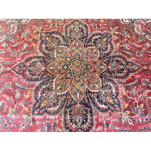 1042 - Vintage Red Ground Persian Heriz Rug from Iran.  Measures approx 290 x 200 cm.