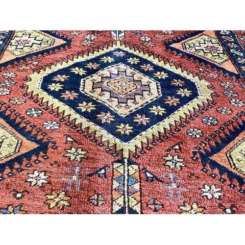 1043 - Terracotta Ground Persian Kashqai Nomadic Rug.  Approx 3 m x 120 cm.