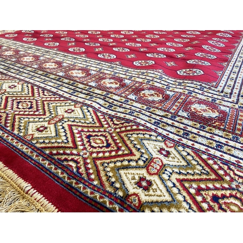 1048 - Rich Red Ground Full Pile Kashmir Carpet, all over Bokhara design.  Measures 2 m x 3 m.