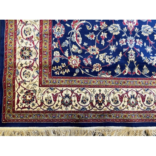 1049 - A Handmade Belgian Wool and Silk Rug. Beige ground. Measures 250 by 150m. In very good condition.