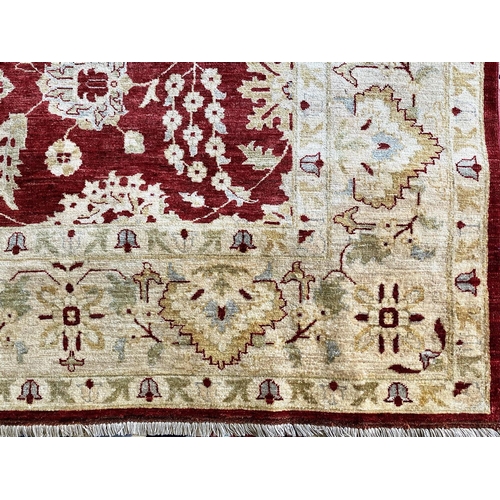 1050 - A Handmade Egyptian Rug. Red and Beige ground. Complete with certificate of authenticity and origin ... 