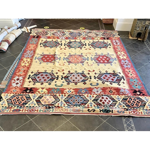 1054 - An Aztec Design Woolen Rug, Beige Ground, Bright Geometric Decoration, 360 x 275cm.