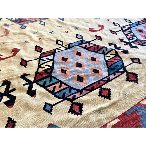 1054 - An Aztec Design Woolen Rug, Beige Ground, Bright Geometric Decoration, 360 x 275cm.