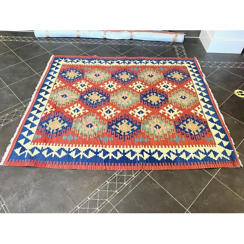 1057 - An Aztec Design Woolen Rug, Red Ground, Bright Geometric Decoration, 220 x 190 cm.