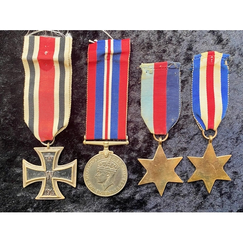 1309 - A German WW1 Iron Cross, together with three WWII medals.