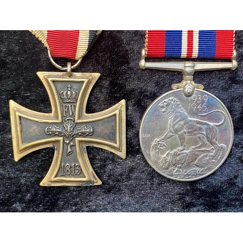 1309 - A German WW1 Iron Cross, together with three WWII medals.