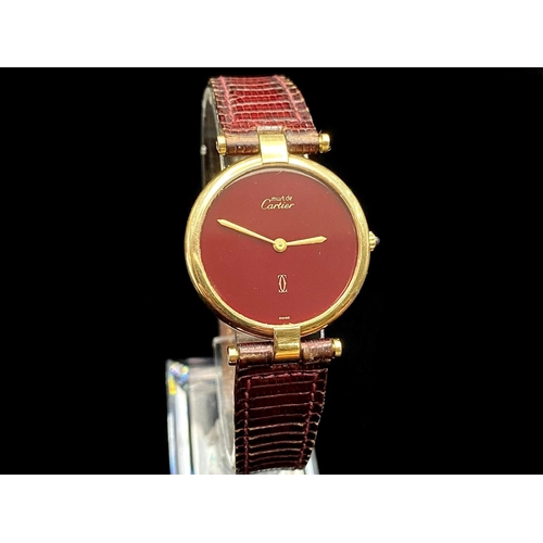 146 - Cartier Paris Ladies Vermeil Gold on Silver Quartz Wrist Watch, features a black dial, 20 microns of... 