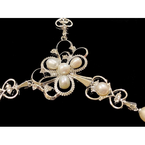 254 - White Cultured Pearl and Austrian Crystal Y Shape Necklace, the pearls set in an openwork design inc... 