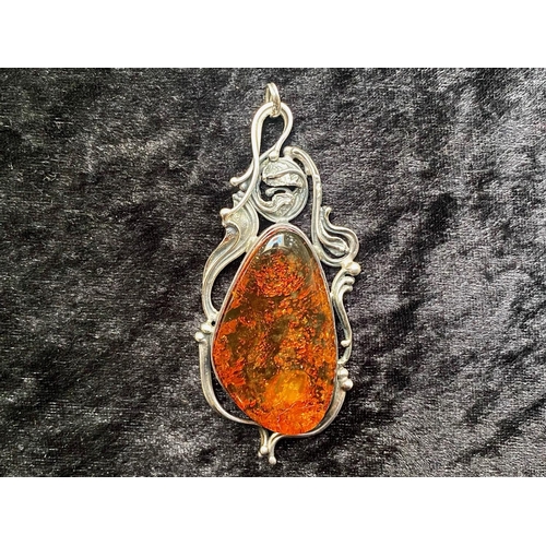 444 - Large Baltic Amber Pendant in sinuous silver mount; amber 1.9 inches (4.8cms) long, silver mount, ma... 