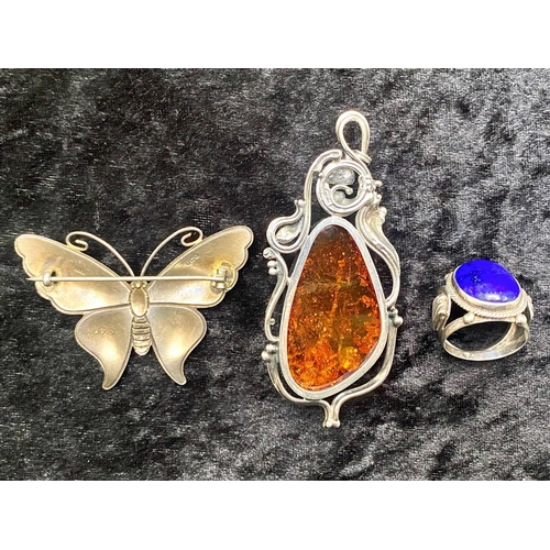 444 - Large Baltic Amber Pendant in sinuous silver mount; amber 1.9 inches (4.8cms) long, silver mount, ma... 