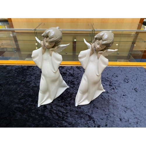 611 - Two Lladro Angels, measuring approx. 9'' tall, 'Curious Angels'.  In excellent condition.  HN 4960.