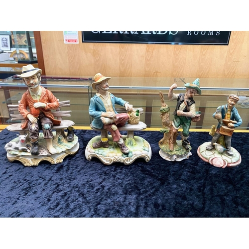 630 - Four Capo di Monte Figures, comprising 2 x  tramp on a bench, and 2 x fisherman.  Tallest 9''.