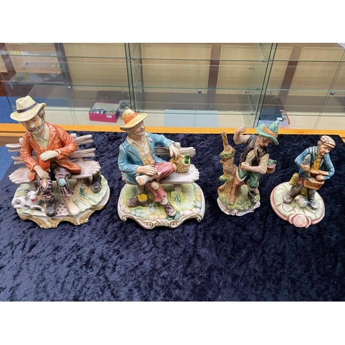 630 - Four Capo di Monte Figures, comprising 2 x  tramp on a bench, and 2 x fisherman.  Tallest 9''.