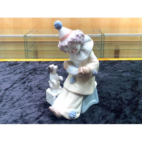 634 - Lladro Pierrot Clown with Puppy & Concertina.  No. 5279. Dated 1984, measures 6'' tall.